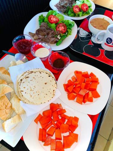 a table with plates of food on a table at Hotel Sociedad y Maristas in Tecolutla