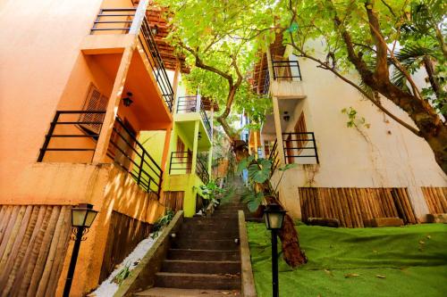 a stairway leading up to a building with a tree at Pura Vida Hostel in Rio de Janeiro