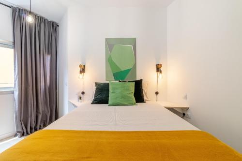 Postel nebo postele na pokoji v ubytování Flatguest Paez Suites