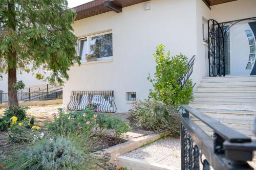un banco frente a una casa con flores en Une HALTE Quelque PART, en Cheminot