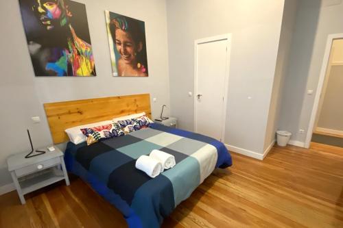 
a bedroom with a bed, a desk and a painting on the wall at Arc House Madrid - Puerta del Sol Only Adults in Madrid
