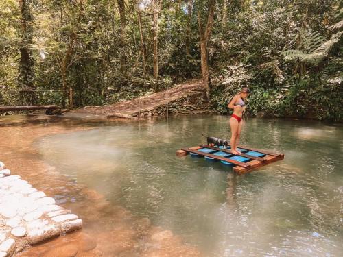 a woman standing on a raft in the water at Hotel del Bosque in Río Cuarto