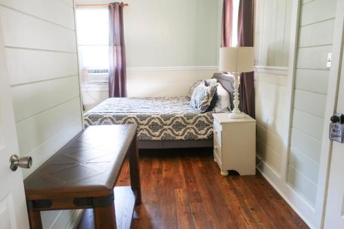 a small bedroom with a bed and a window at Blackbeard's Lodge in Ocracoke
