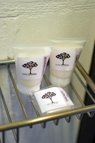 two candles with trees on them on a shelf at Vila Pitanga Hosting in Sao Paulo