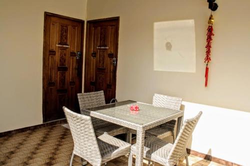 a dining room with a glass table and chairs at TAHITI - Sanny's Place Family Room & Poo in Punaauia