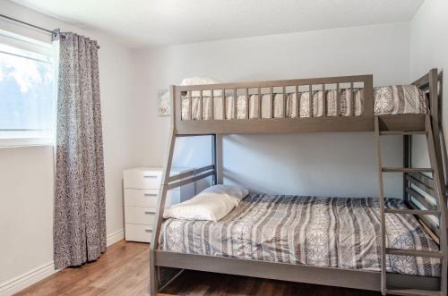 a bedroom with two bunk beds and a window at Never Stop Exploring- 3 bedroom 2 bath home of duplex, close to Zion, Bryce, and Brianhead in Cedar City