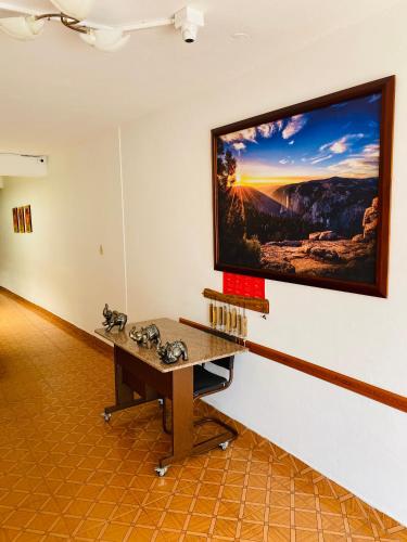 a large flat screen tv hanging on a wall at Hotel Paso Realce in Guaduas