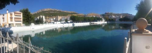 a large body of water with buildings and mountains at ALOJAMIENTO LA EXPLANADA in Pegalajar