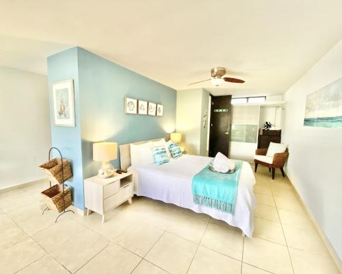 a large bedroom with a bed and a chair at KASA Seahorse of the Sea - Studio for 2 BEACH BLOCK in San Juan