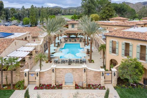 an aerial view of a resort with a swimming pool and palm trees at Westlake Village Inn in Westlake Village