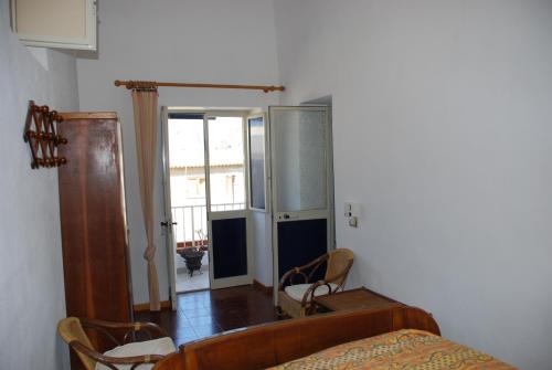 a bedroom with a bed and a door to a room at Vulcanoconsult Appartamenti Spiaggia in Lipari