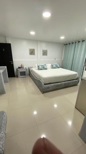 a bedroom with a large bed with blue curtains at Le Castel Blanc Hotel Boutique in San Andrés