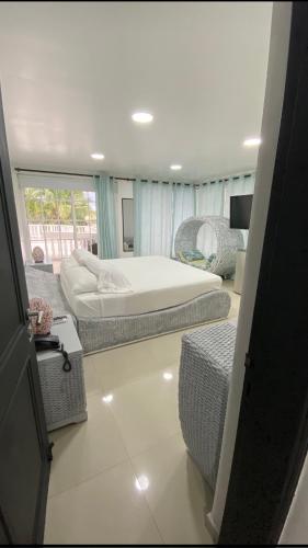 a bedroom with two beds and a living room at Le Castel Blanc Hotel Boutique in San Andrés