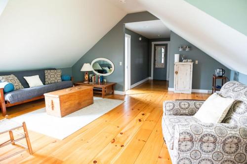 a living room with a couch and a table at Craftsbury Farmhouse in Craftsbury