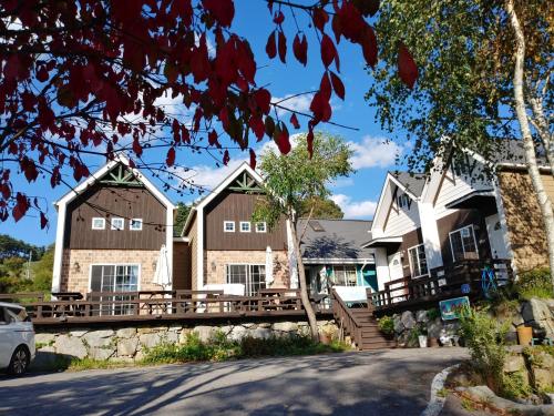 a house with a bridge over a street at Soop and Soop Pension in Pyeongchang 