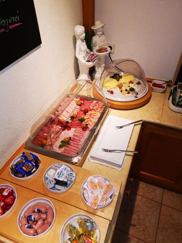 a table with plates of food on top of it at Airport Hotel Filder Post in Stuttgart