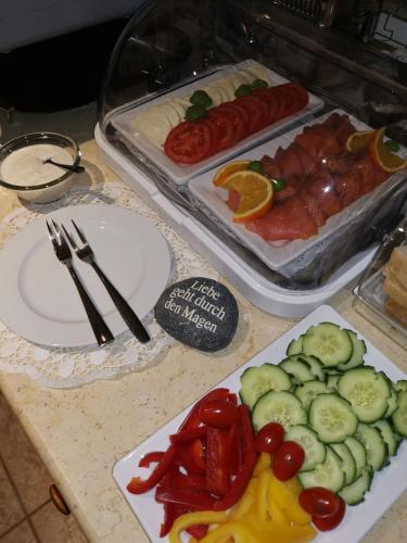a table with plates of food on a counter at Airport Hotel Filder Post in Stuttgart