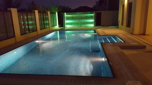 a swimming pool at night with the lights on at Royal Sea View Villa with Private Pool in Ras al Khaimah