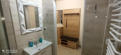 a bathroom with a sink and a mirror at Magdalenka in Legnica