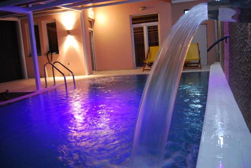 a swimming pool with a waterfall in a house at Villa Milka in Ohrid