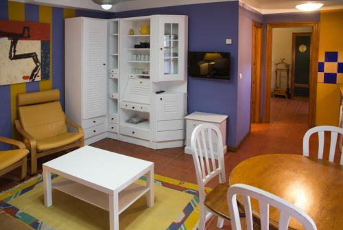 a living room with a table and a dining room at Apartamentos Alquitara in Potes