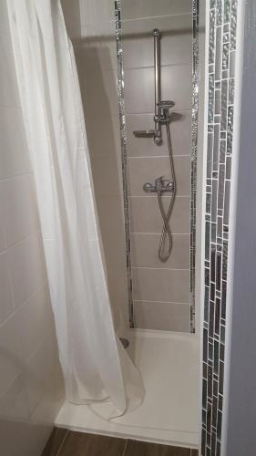 a bathroom with a shower with a shower curtain at Chambres de Sauviolle in Frontenac