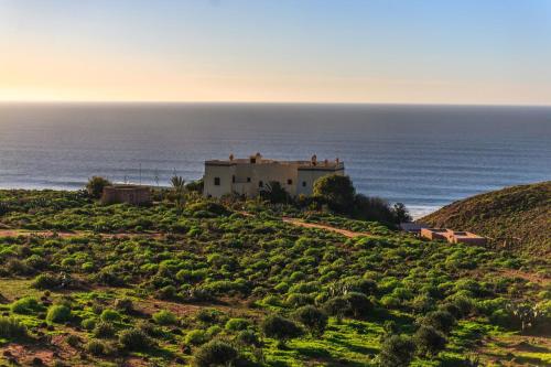 
a view from the top of a hill overlooking the ocean at Kasbah Tabelkoukt in Mirleft
