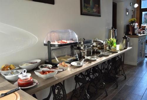 a table with many dishes of food on it at Penzion Pod Rozhlednou in Janov