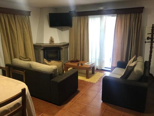 a living room with two chairs and a fireplace at Casa Lola Principe in Geres