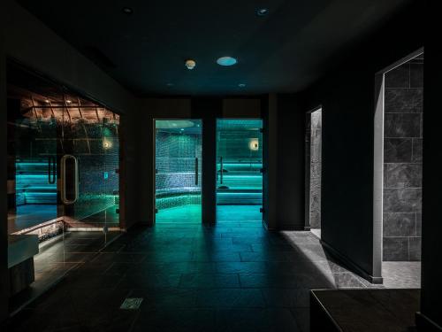 a dark room with a hallway with green lights at Hotel National Zermatt in Zermatt