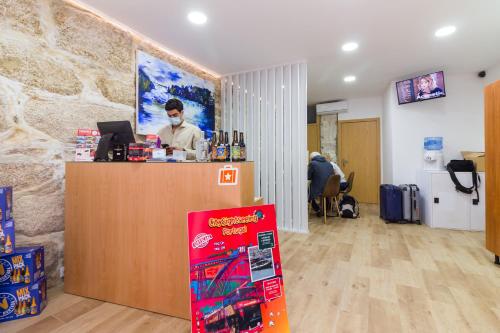 a man standing at a counter in a room at Oporto Near Apartments in Porto