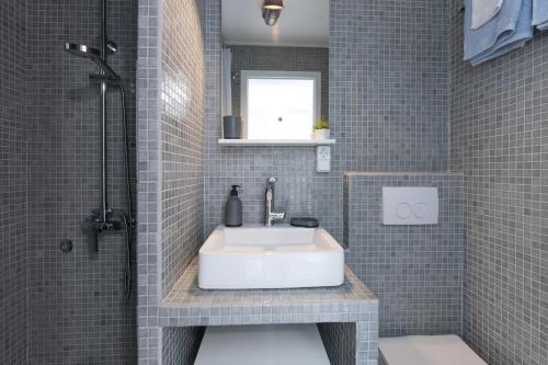 a bathroom with a white sink and a shower at Apartment Alida in Krk