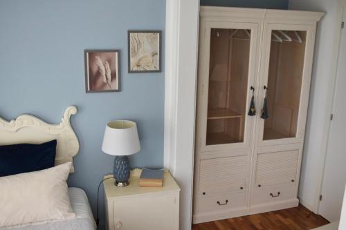 a bedroom with a white cabinet and a bed at Casa Doramas VV in Las Palmas de Gran Canaria