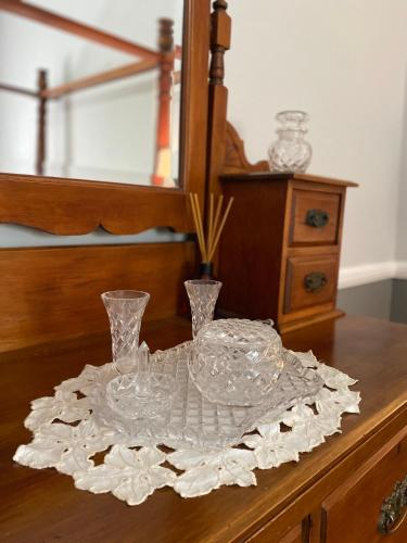 a table with two glasses on top of a table at Palmyra B&B in Rainbow Flat
