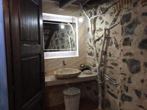 a bathroom with a sink and a mirror at Hotel Anticos Palathos in Orosei
