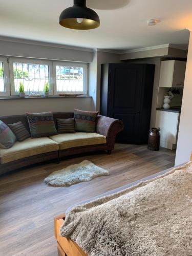 a living room with a couch and some windows at African Suite - Maintal bei Frankfurt in Maintal
