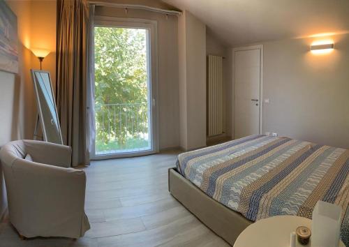 a bedroom with a bed and a large window at Villa moderna a Forte dei Marmi in Forte dei Marmi