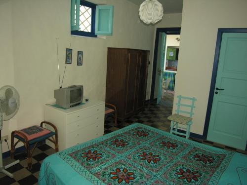 a bedroom with a bed and a tv and a dresser at Vulcanoconsult Appartamenti Spiaggia in Lipari