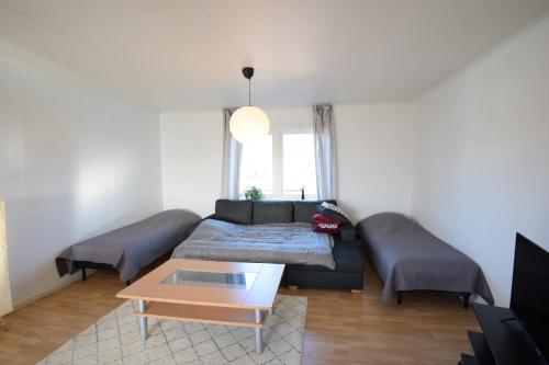 a living room with a couch and a table at Big Apartment in central Kiruna 6 in Kiruna
