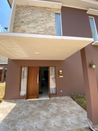 a home entrance with a walkway leading into a house at Marseillia Hills in Puncak