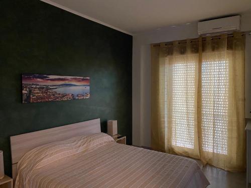 a bedroom with a bed and a large window at Nidama house in Naples