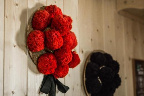 a bunch of red flowers hanging on a wall at Zur grossen Tanne in Bühl