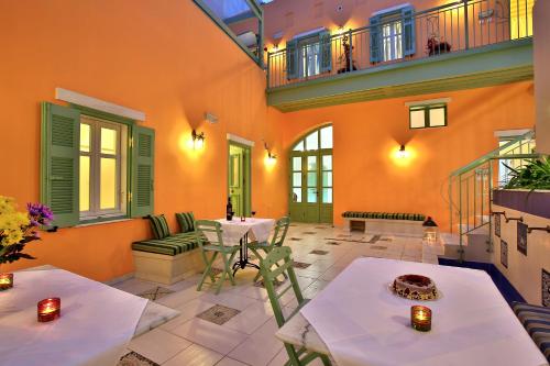 a living room with two tables and a balcony at Efchi 1904 in Rhodes Town