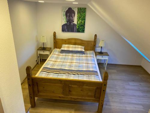 a bedroom with a wooden bed in a room at Pension Luna in Hildesheim