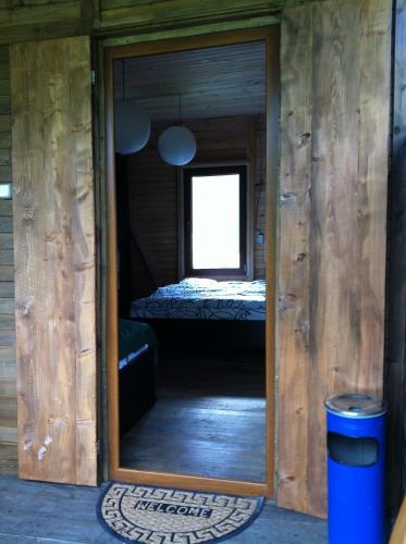 a door into a room with a bed in it at Zeta Camping in Jut'a