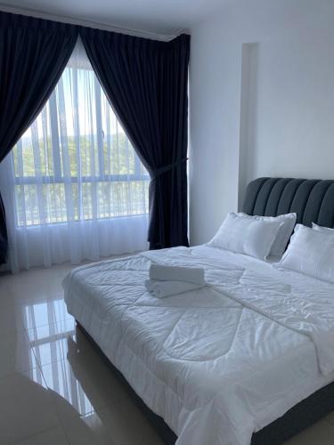 a bedroom with a large bed with a large window at Sumayyah Homestay @ Casa Kayangan in Ipoh