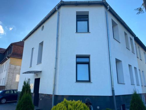 a white building with windows on the side of it at Pension Luna in Hildesheim