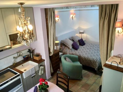 a small room with a bed and a kitchen with a table at Enjoy Mougins in Mougins