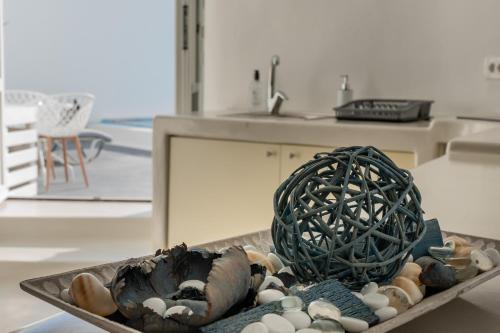 a tray of shells and a vase on a table at Cally Cave House in Fira