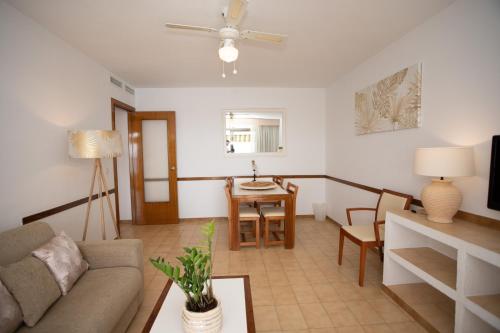 a living room with a couch and a table at Apartamentos María Cristina Beach in Benidorm